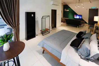 a living room with a large bed and a table at 3Towers @ KL City Centre in Kuala Lumpur