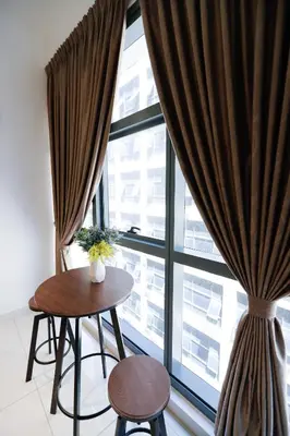a table and chairs in front of a large window at 3Towers @ KL City Centre in Kuala Lumpur