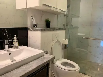 a bathroom with a toilet and a sink and a shower at The Platinum KLCC By Victoria Home in Kuala Lumpur