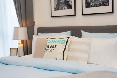 a bed with a bunch of pillows on it at Royce Residence KLCC, Kuala Lumpur City Center, COBNB in Kuala Lumpur