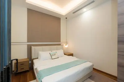 a bedroom with a white bed and a window at Royce Residence KLCC, Kuala Lumpur City Center, COBNB in Kuala Lumpur