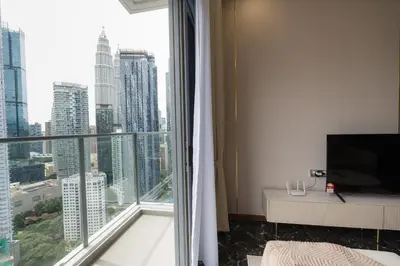 a room with a large window with a view of a city at Royce Residence KLCC, Kuala Lumpur City Center, COBNB in Kuala Lumpur