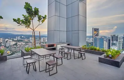 a patio with tables and chairs on a building at Royce Residence KLCC, Kuala Lumpur City Center, COBNB in Kuala Lumpur