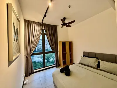 a bedroom with a bed and a ceiling fan at Neu Suites Service Apartment in Kuala Lumpur