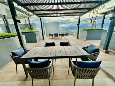 a patio with a table and chairs on a building at Neu Suites Service Apartment in Kuala Lumpur
