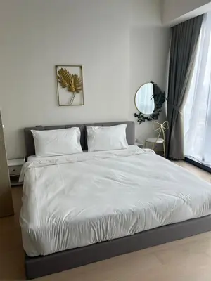 a bedroom with a bed with white sheets and a mirror at Star Residence Klcc By M&T in Kuala Lumpur