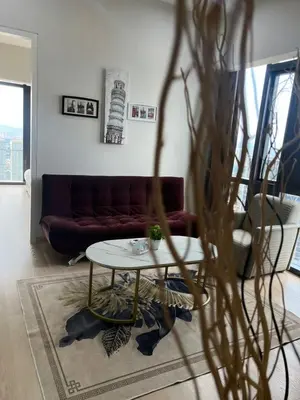 a living room with a table and a couch at Star Residence Klcc By M&T in Kuala Lumpur