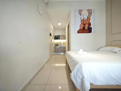 a bedroom with two beds and a painting on the wall at TRION Studio 4 PAX Teneighth in Kuala Lumpur
