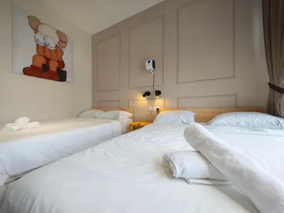 two beds in a room with white sheets at TRION Studio 4 PAX Teneighth in Kuala Lumpur