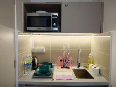 a kitchen counter with a sink and a microwave at TRION Studio 4 PAX Teneighth in Kuala Lumpur