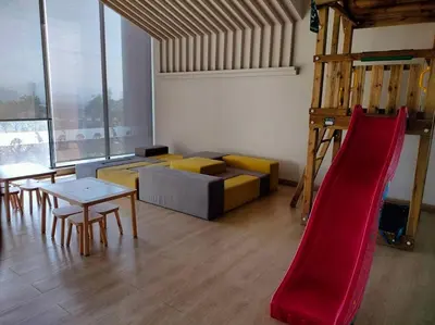 a living room with a couch and a slide at Central KL Retreat MyTown Ikea KLCC TRX Mall MRT in Kuala Lumpur