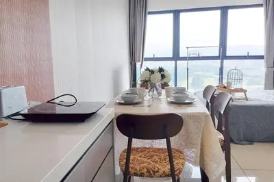 a kitchen with a table with a laptop on it at Central KL Retreat MyTown Ikea KLCC TRX Mall MRT in Kuala Lumpur