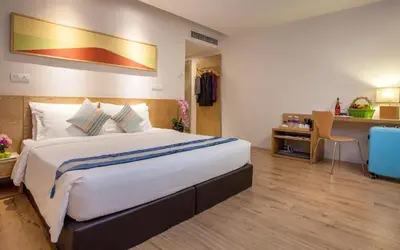 a hotel room with a large bed and a desk at de King Hotel KLCC in Kuala Lumpur