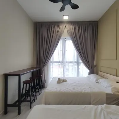 a bedroom with two beds and a desk and a window at TRION studio 4 PAX tenseven in Kuala Lumpur