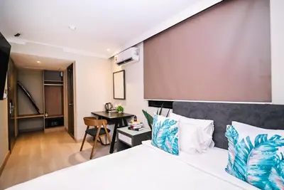 a hotel room with a bed and a table at Kingston Hotel 6 - Changkat, Bukit Bintang in Kuala Lumpur
