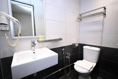 a bathroom with a sink and a toilet and a mirror at Kingston Hotel 6 - Changkat, Bukit Bintang in Kuala Lumpur