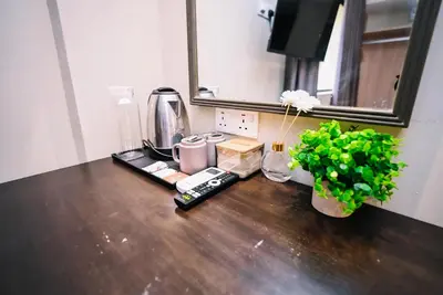 a kitchen counter with a coffee maker and a plant at Kingston Hotel 6 - Changkat, Bukit Bintang in Kuala Lumpur