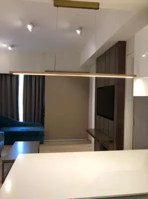 a living room with a couch and a television at Star Residence KlCC By M&T in Kuala Lumpur