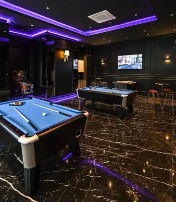 a billiard room with two pool tables and a tv at Star Residence KlCC By M&T in Kuala Lumpur