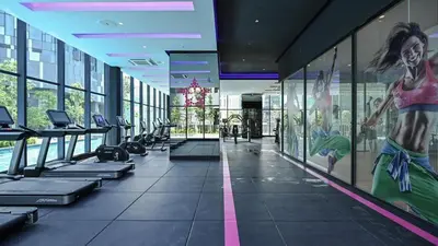 a gym with treadmills and a painting on the wall at Star Residence KlCC By M&T in Kuala Lumpur