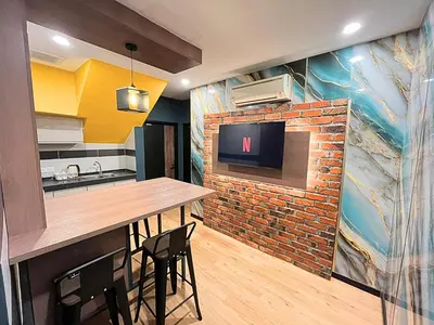a kitchen with a bar and a brick wall at Seeds Hotel Cheras Maluri in Kuala Lumpur