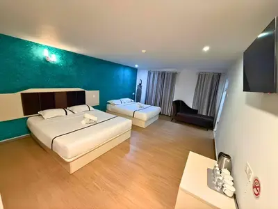 a hotel room with a bed and a couch at Seeds Hotel Cheras Maluri in Kuala Lumpur