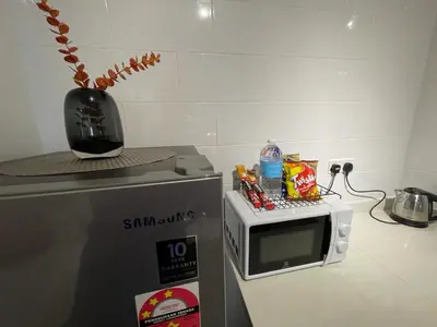 a microwave oven sitting on top of a refrigerator at Anggun Arte Mont Kiara in Kuala Lumpur
