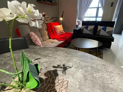 a living room with a table and a couch at Anggun Arte Mont Kiara in Kuala Lumpur