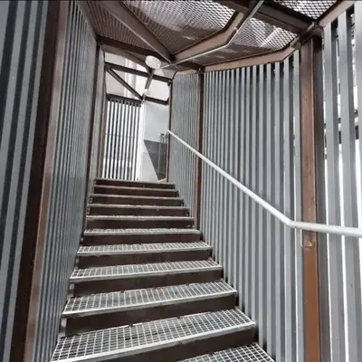 a metal staircase in a building with a stair railing at Chill-houz KL Trion 6P 2BR - 5-mins MRT - TRX Mall in Kuala Lumpur
