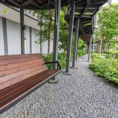 a wooden bench sitting under a building at Chill-houz KL Trion 6P 2BR - 5-mins MRT - TRX Mall in Kuala Lumpur