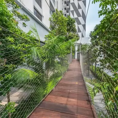 a walkway with a fence in front of a building at Chill-houz KL Trion 6P 2BR - 5-mins MRT - TRX Mall in Kuala Lumpur