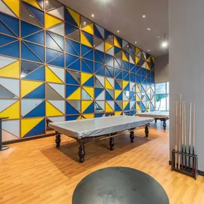 a room with two tables and a colorful wall at Chill-houz KL Trion 6P 2BR - 5-mins MRT - TRX Mall in Kuala Lumpur