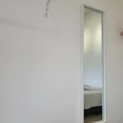 a mirror in a bedroom next to a bed at Chill-houz KL Trion 6P 2BR - 5-mins MRT - TRX Mall in Kuala Lumpur