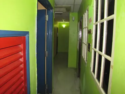 a hallway of a room with green and blue walls at Oasis Guest House in Kuala Lumpur