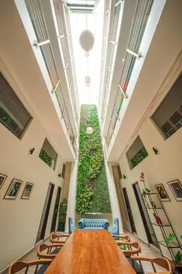 a long table in a room with a vertical plant at The Mesui Hotel Bukit Bintang in Kuala Lumpur