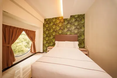 a bedroom with a bed and a window at The Mesui Hotel Bukit Bintang in Kuala Lumpur