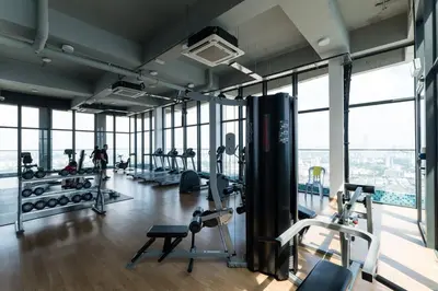 a gym with cardio equipment in a building at Duplex Industrial Loft 5pax above Eko Cheras Mall in Kuala Lumpur