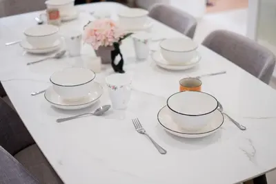 a white table with plates and utensils on it at Duplex Industrial Loft 5pax above Eko Cheras Mall in Kuala Lumpur