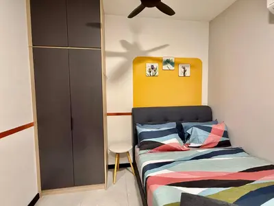 a bedroom with a bed and a yellow headboard at Couple Suite at Neu Suites near Gleneagles in Kuala Lumpur