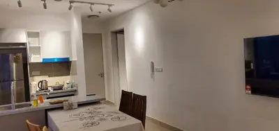 a kitchen with a table and a kitchen with a kitchen gmaxwell gmaxwell gmaxwell at Trion KL in Kuala Lumpur