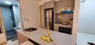 a kitchen with a sink and a stainless steel refrigerator at Trion KL in Kuala Lumpur