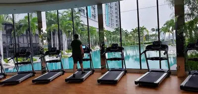 a man is walking on treadmills in a gym at Trion KL in Kuala Lumpur
