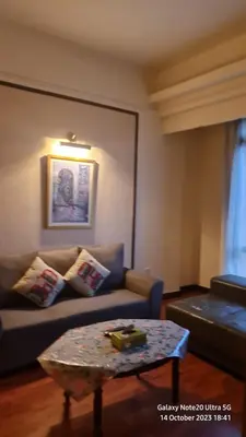 a living room with a couch and a coffee table at Regal Servies Suites at Times Square KL in Kuala Lumpur