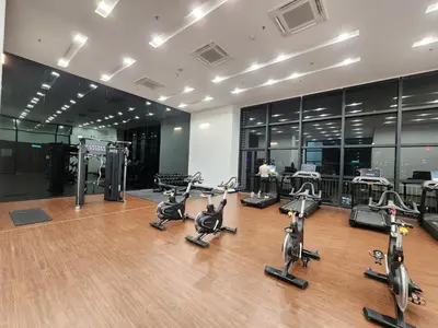 a gym with several treadmills and exercise bikes at Chambers Suites KLCC Serviced Apartment in Kuala Lumpur