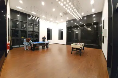 two people playing pool in a room with a pool table at Chambers Suites KLCC Serviced Apartment in Kuala Lumpur