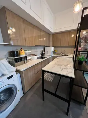 a kitchen with a washer and a washing machine at Elisa Sentrio Pandan Suites in Kuala Lumpur