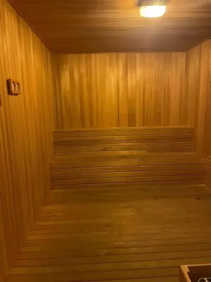 a wood paneled room with a row of benches at Elisa Sentrio Pandan Suites in Kuala Lumpur