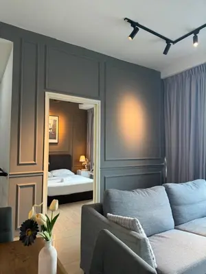 a living room with a couch and a bedroom at FHS Homestay @ Arte Plus Jalan Ampang T3-33A-07 in Kuala Lumpur