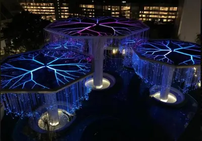 a group of umbrellas are lit up at night at FHS Homestay @ Arte Plus Jalan Ampang T3-33A-07 in Kuala Lumpur