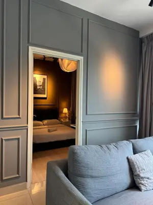 a living room with a couch and a bedroom at FHS Homestay @ Arte Plus Jalan Ampang T3-33A-07 in Kuala Lumpur